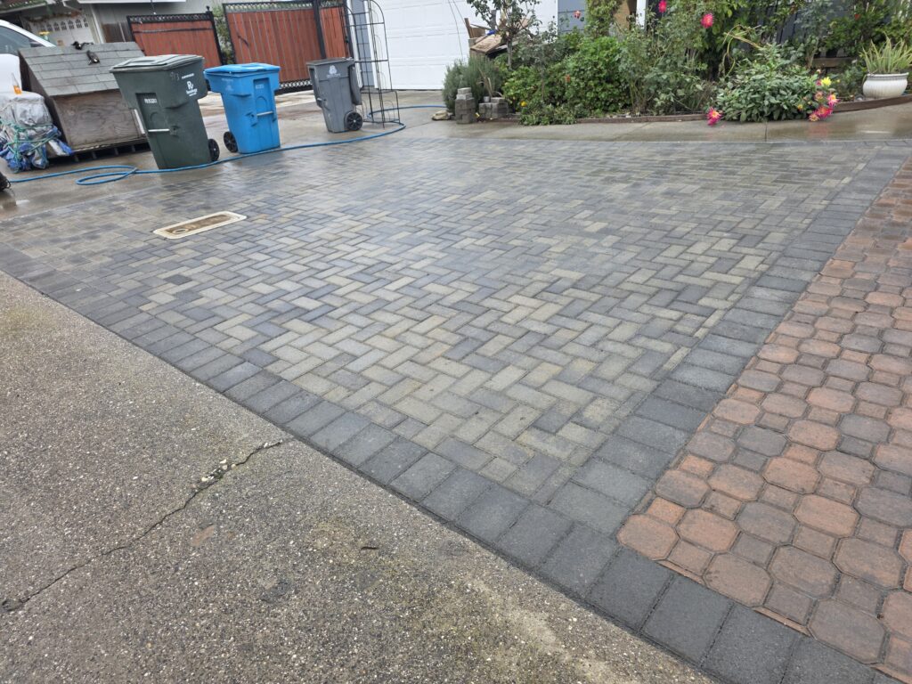 Patio pavers add an artistic touch to this driveway Rodriguez Landscape Services